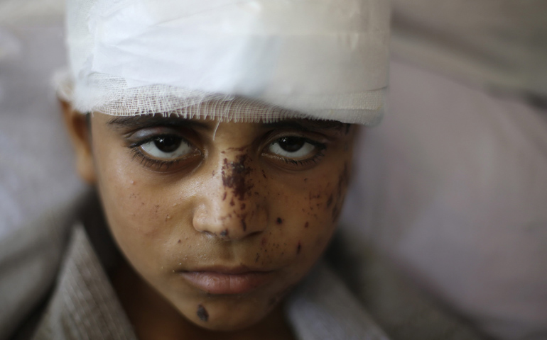Mahmoud al-Ghol, 10, was pulled from beneath the rubble of a house in Gaza, which witnesses said was destroyed in an Israeli air strike that killed nine members of his family. (CNS/Reuters/Ibraheem Abu Mustafa)