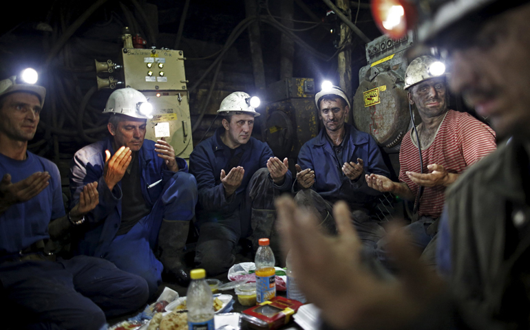 Coal miners pray July 15 inside the Stara Jama mine in Zenica, Bosnia and Herzegovina. (CNS/Reuters/Dado Ruvic)