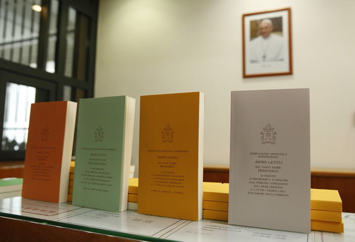 Copies of Pope Francis' apostolic exhortation on the family, "Amoris Laetitia" ("The Joy of Love"), are seen during the document's release at the Vatican April 8. (CNS/Paul Haring)