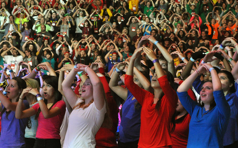 At the opening session of the National Catholic Youth Conference in Indianapolis Nov. 21, teens sing and move to a song in Lucas Oil Stadium. (CNS photo/Natalie Hoefer, The Criterion)