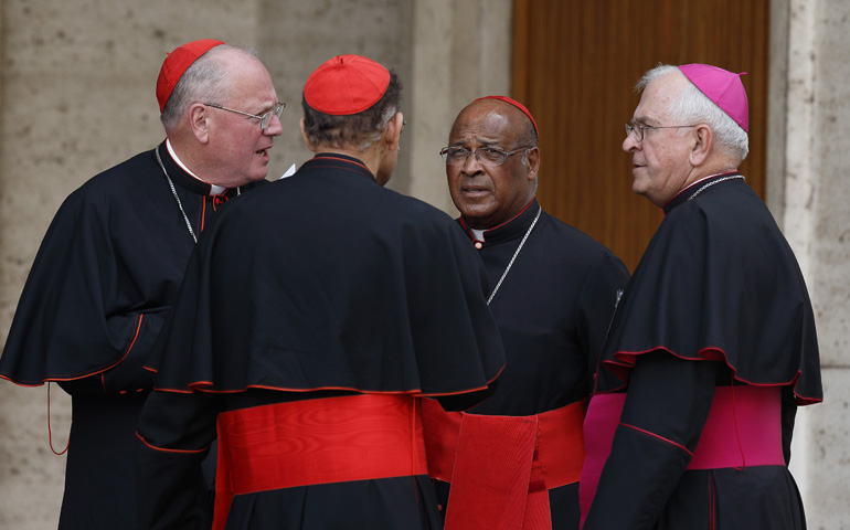 From left: Cardinal Timothy Dolan of New York; Cardinal Oswald Gracias of Mumbai, India; Cardinal Wilfrid Napier of Durban, South Africa; and Archbishop Joseph Kurtz of Louisville, Ky., talk after leaving the morning session of the extraordinary Synod of Bishops on the family Monday at the Vatican. (CNS/Paul Haring)