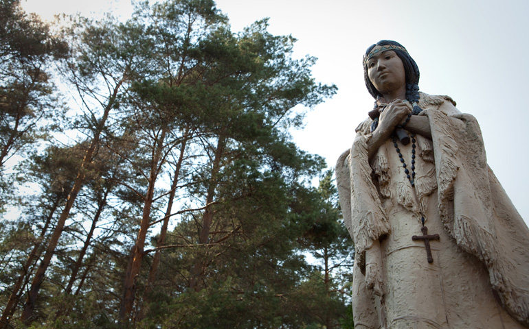 A statue of St. Kateri Tekakwitha stands amid trees on the grounds of the shrine dedicated to her in Fonda, N.Y. The 17th-century Mohawk-Algonquin woman is the first member of a North American tribe to be declared a saint. (CNS/Nancy Phelan Wiechec)