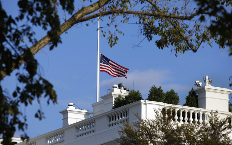 A U.S. flag flies at half staff Monday at the White House in remembrance of victims of a shooting at the Washington Navy Yard that day. (CNS/Reuters/Yuri Gripas)