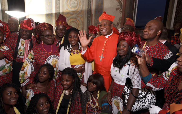 New Cardinal John Olorunfemi Onaiyekan of Abuja, Nigeria, poses with pilgrims from his country during a reception for six new cardinals Saturday in the Apostolic Palace at the Vatican. (CNS/Paul Haring)