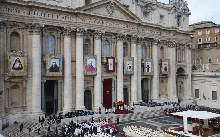 The banners of six Italian and Indian saints hang from the facade of St. Peter's Basilica as Pope Francis celebrates their canonization Mass on Sunday in St. Peter's Square at the Vatican. (CNS/Paul Haring) 