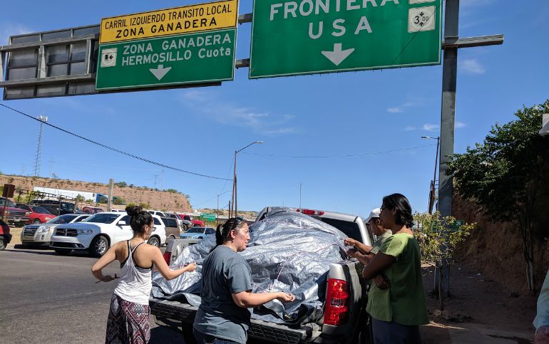 Sr. Maribel Lara, right, in green, meets with donors bringing items for people whom she and other Sisters of the Eucharist will serve at the Nogales, Mexico, Aid Center for Migrants. (Peter Tran)