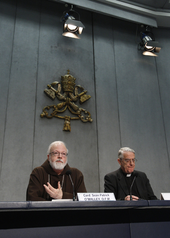 Boston Cardinal Sean O'Malley, a member of Pope Francis' advisory Council of Cardinals, speaks during a press conference Thursday at the Vatican. At the press conference, O'Malley announced that Pope Francis accepted a proposal from the council to establish a special commission on the sexual abuse of children. At right is Jesuit Fr. Frederico Lombardi, the Vatican spokesman. (CNS/Paul Haring) 