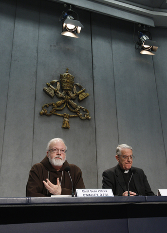 Boston Cardinal Sean O'Malley, a member of Pope Francis' advisory Council of Cardinals, speaks during a press conference Thursday at the Vatican. At the press conference, O'Malley announced that Pope Francis accepted a proposal from the council to establish a special commission on the sexual abuse of children. At right is Jesuit Fr. Frederico Lombardi, the Vatican spokesman. (CNS/Paul Haring)