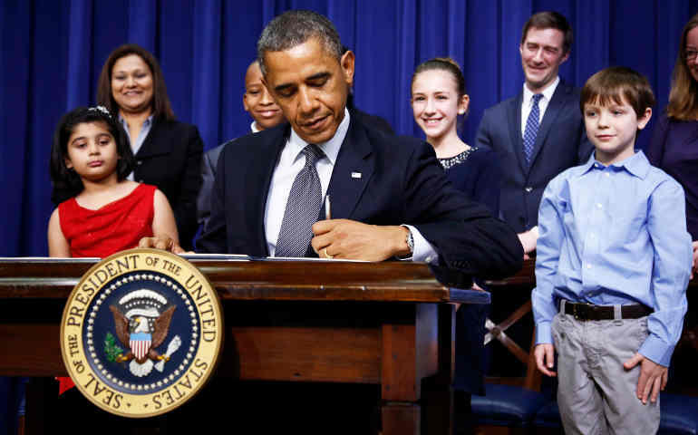 President Obama signs executive orders on ways to address gun violence President Barack Obama signs executive orders on ways to address gun violence Jan. 16 at the White House in Washington. He is flanked by letter- writers Hinna Zeejah, 8, Taejah Goode, 10, Julia Stokes, 11, and Grant Fritz, 8. The children wrote the presi dent about gun violence following the Dec. 14 shooting at Sandy Hook Elementary school in Newtown, Conn. (CNS photo/Jason Reed, Reed)