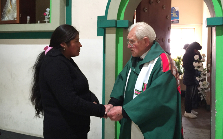 Fr. Sebastian Obermaier talks with a woman July 4 in El Alto, Bolivia. (CNS/David Agren)