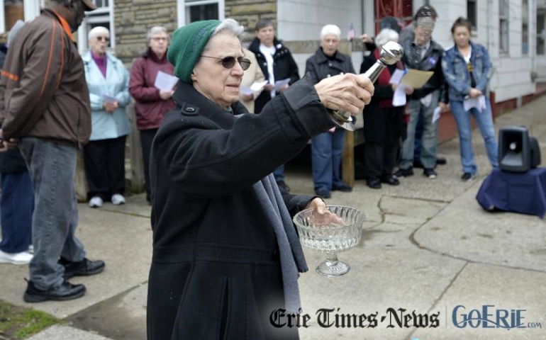 Mercy Sr. Mary Paul sprinkles holy water during a vigil for Robert McCarthy outside his Erie home March 28. McCarthy was stabbed to death and set on fire Feb. 5 outside his home on East Ninth Street in Erie. (Erie Times-News/Dave Munch/Reprinted with permission from Times Publishing Company, Erie, PA, Copyright 2017)