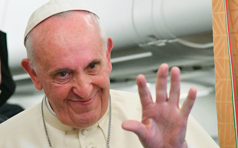 Pope Francis gestures as he speaks to journalists on his flight Oct. 2, 2016, back to Rome following a visit in Georgia and Azerbaijan. (Reuters/Luca Zennaro/Pool)