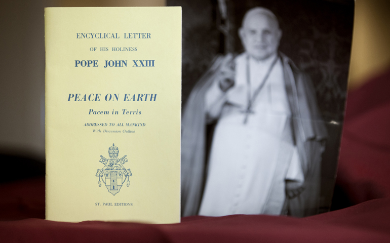 An early edition of the encyclical "Peace on Earth" ("Pacem in Terris") is pictured next to a photo of its author, Pope John XXIII. (CNS/Nancy Phelan Wiechec) 