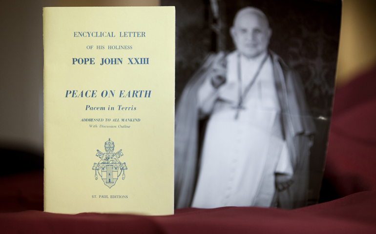 An early edition of the encyclical "Peace on Earth" ("Pacem in Terris") is pictured next to a photo of its author, Pope John XXIII. (CNS/Nancy Phelan Wiechec)