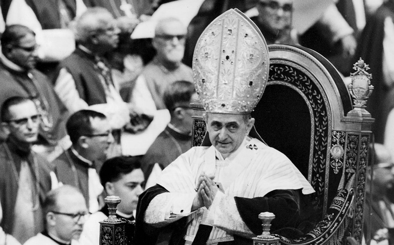 Pope Paul VI makes his way past bishops during a session of the Second Vatican Council in 1964. (CNS file photo) 