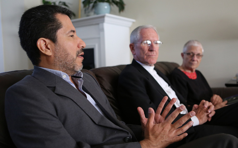 Jose Henriquez, secretary-general of Pax Christi International, gestures during an interview Tuesday at the Maryknoll guest house in Washington. Looking on are the two co-presidents of Pax Christi International, Bishop Kevin Dowling of Rustenburg, South Africa, and Marie Dennis. (CNS/Bob Roller)