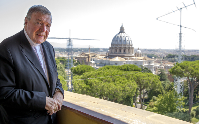 Cardinal George Pell, prefect of the Vatican Secretariat for the Economy, poses Aug. 5, 2014, outside his office in St. John's Tower overlooking St. Peter's Basilica. (CNS/Robert Duncan)