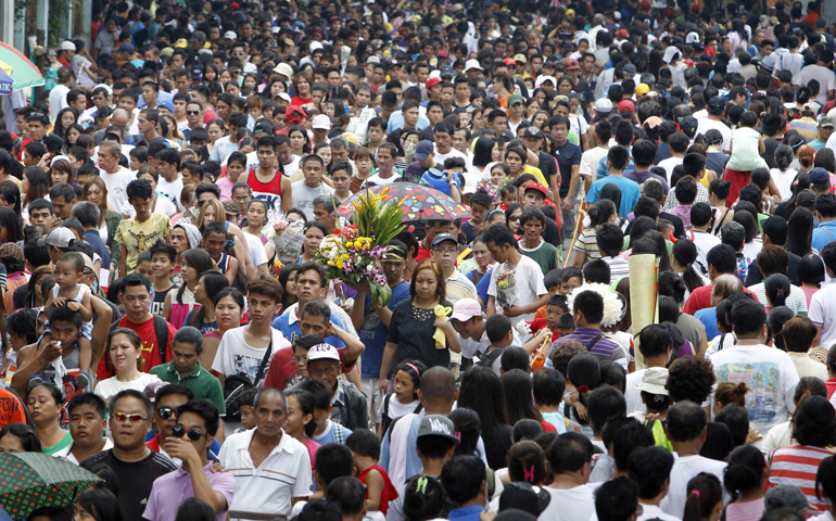 Filipinos walk to a public cemetery on Nov. 1, 2013, to remember their departed loved ones on All Saints' Day. (CNS/Reuters/Romeo Ranoco)