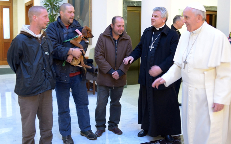 Pope Francis talks with three men Tuesday who live on the streets near the Vatican. (CNS/Reuters/L'Osservatore Romano)