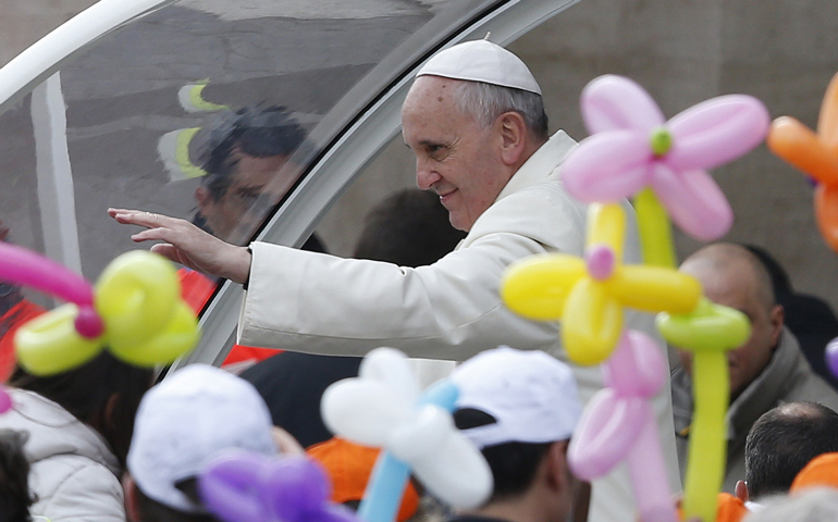 Balloons are seen as Pope Francis greets the crowd as he arrives for his general audience Wednesday in St. Peter's Square at the Vatican. (CNS/Paul Haring)