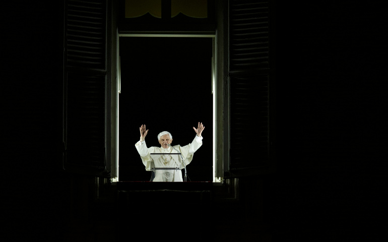 Pope Benedict XVI greets pilgrims from the window of his apartment after briefly addressing a candlelit vigil Thursday in St. Peter's Square at the Vatican to mark the 50th anniversary of the opening of the Second Vatican Council. (CNS/Paul Haring)