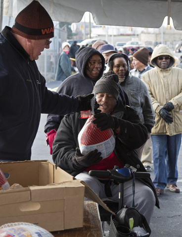 People in need line up for free Thanksgiving turkeys in 2013 in Detroit. (CNS/Jim West) 
