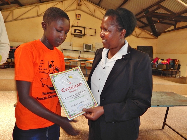 At the end of the seminar, Sr. Ephigenia Gachiri, right, presents each participant with a certificate of completion, signaling her transition to womanhood. (GSR photo/Atieno Otieno)