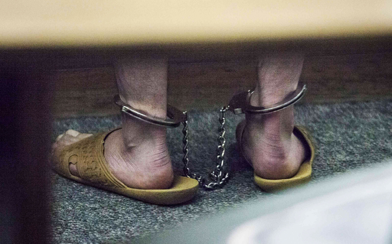 Aaron Ybarra stands with legs shackled together while he appears in court June 6, 2014, at the King County Jail in Seattle. Ybarra is accused of killing one person and wounding two others in a shooting spree at a small Christian college in Seattle. (CNS/Reuters/David Ryder)