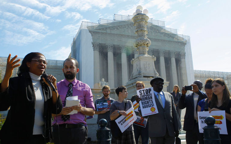 Plaintiff Esther Kiobel, left, joins a protest against Royal Dutch Shell Petroleum in front of the U.S. Supreme Court in Washington Oct. 1. (Newscom/Reuters/Gary Cameron)