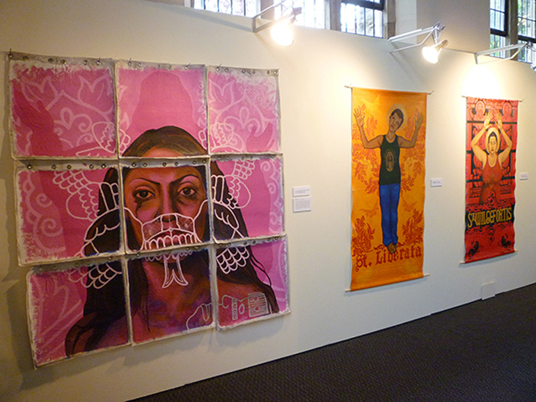 Three works by artist Alma Lopez in her show, "Queer Santas: Holy Violence," on display at the Pacific School of Religion. (RNS/Kimberly Winston) 