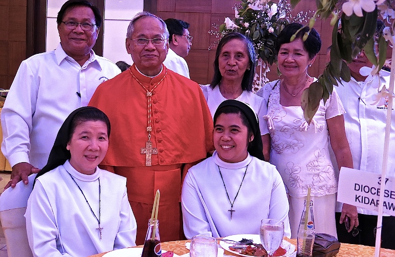 Cardinal Orlando Quevedo poses with Religious of the Virgin Mary nuns and lay guests at 75th birthday testimonial dinner and program in South Seas Mall, Cotabato City, when he announced he was submitting to the nuncio his resignation letter as required by Canon Law. (N.J. Viehland)
