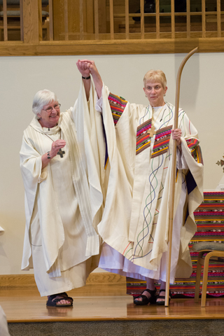 Bishop Regina Nicolosi presents her successor, Nancy Meyer, as bishop of the Roman Catholic Womenpriests' Midwest region. (NCR photo/Dawn Cherie Araujo)