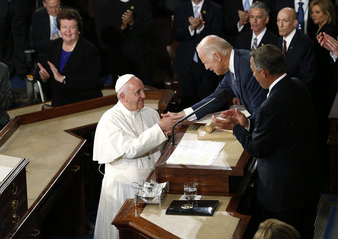 Pope Francis is greeted by U.S. Vice President Joe Biden as the pope arrives in the House Chamber prior to addressing a joint meeting of the U.S. Congress on Capitol Hill in Washington on September 24, 2015. (Reuters/Jonathan Ernst)