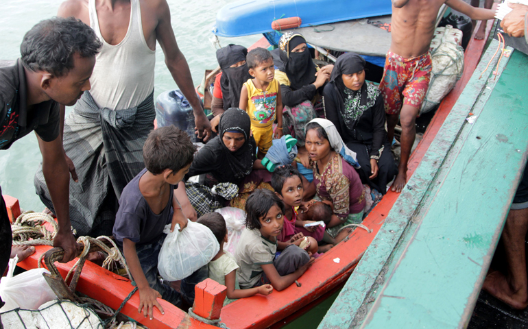 Refugees from Myanmar and Bangladesh are seen in their boat before their rescue by fisherman in Julok, Indonesia, May 20. (CNS/EPA/Stringer)
