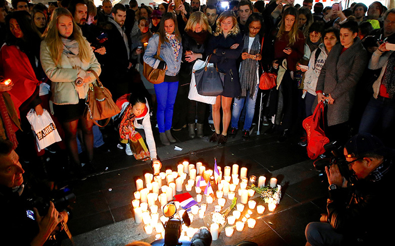 Members of the Australian French community stand around candles during a vigil in central Sydney, Australia, July 15, 2016, to remember the victims of the Bastille Day truck attack in Nice. (Photo courtesy of Reuters/David Gray)