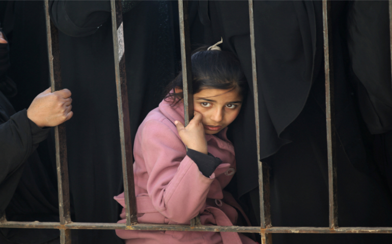 An internally displaced refugee girl from al-Bab town waits to receive food aid Jan. 21, 2017, in Ekhtreen town, northern Aleppo countryside, Syria. (Courtesy of Reuters/Khalil Ashawi)