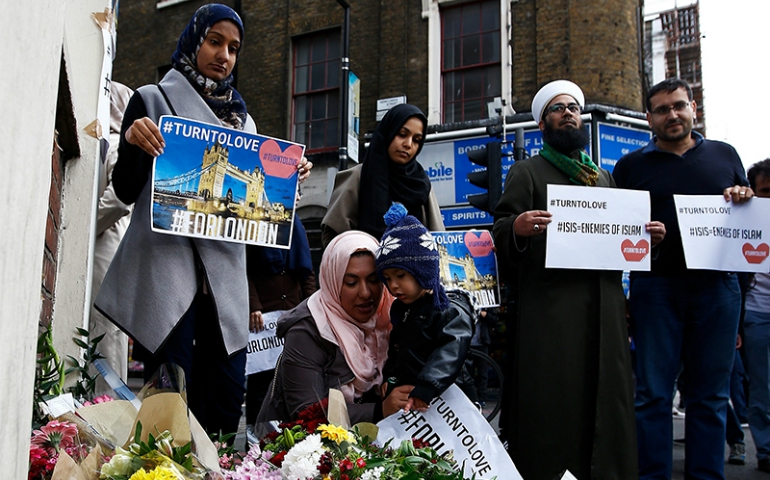 Muslims pray at a floral tribute near London Bridge, after attackers rammed a hired van into pedestrians on London Bridge and stabbed others nearby killing and injuring people, in London on June 3, 2017. (Reuters/Peter Nicholls)
