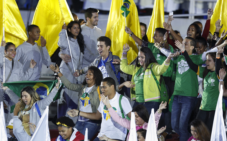 Young people dance and sing Tuesday during the opening ceremony of World Youth Day on Copacabana beach in Rio de Janeiro. (CNS/Paul Haring)