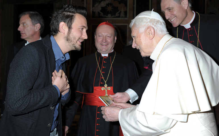 Francesco Lorenzi, lead singer of the Italian rock group The Sun, presents a CD of the band's latest album to Pope Benedict XVI on Thursday at the Vatican. Band members met the pope after performing the previous day to open the plenary meeting of the Pontifical Council for Culture. (CNS/L'Osservatore Romano) 