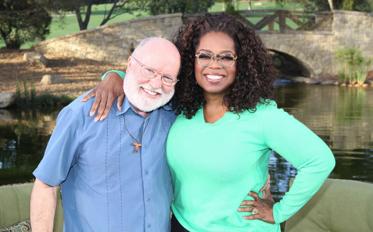 Franciscan Fr. Richard Rohr poses with Oprah Winfrey on the set of "Super Soul Sunday" during the taping of the show Nov. 12. (CNS/Courtesy Harpo Inc./George Burns)