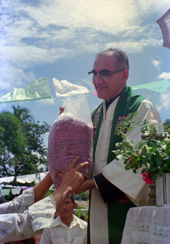Archbishop Oscar Romero receives a sack of beans from parishioners following Mass outside of the church in San Antonio Los Ranchos in Chalatenango, El Salvador, in 1979. (CNS/Octavio Duran)