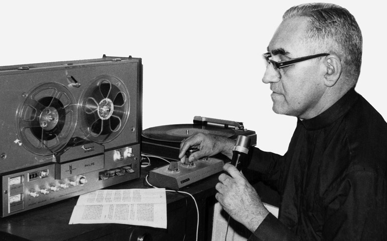 Archbishop Oscar Romero works in an improvised radio studio in San Salvador in this undated photo. (CNS/Octavio Duran) 