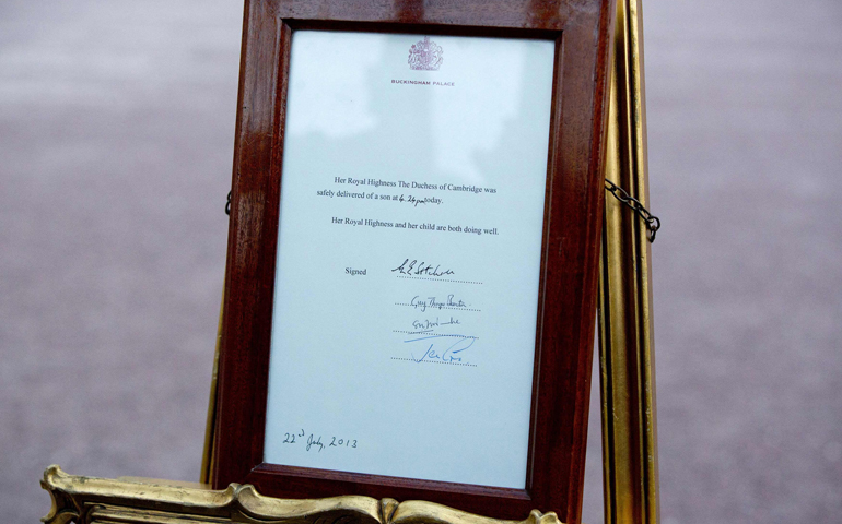 A notice formally announcing the birth of a son to Britain's Prince William and Catherine, Duchess of Cambridge, is placed in front of Buckingham Palace in London on Monday. (CNS/Reuters/Neil Hall)