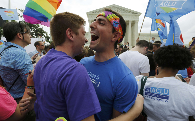 Supporters of same-sex marriage celebrate outside the U.S. Supreme Court building Friday in Washington after the justices ruled in a 5-4 decision that the U.S. Constitution gives same-sex couples the right to marry. (CNS/Reuters/Jim Bourg)