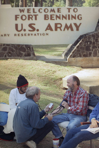 Bill Barnett, center, takes the blood pressure of David Scott of Detroit Sept. 27, 1990, at Fort Benning, Ga., as Scott and other hunger strikers continue their protest begun Sept. 3 to end U.S. training of Salvadoran troops. (AP/Charles Kelly)