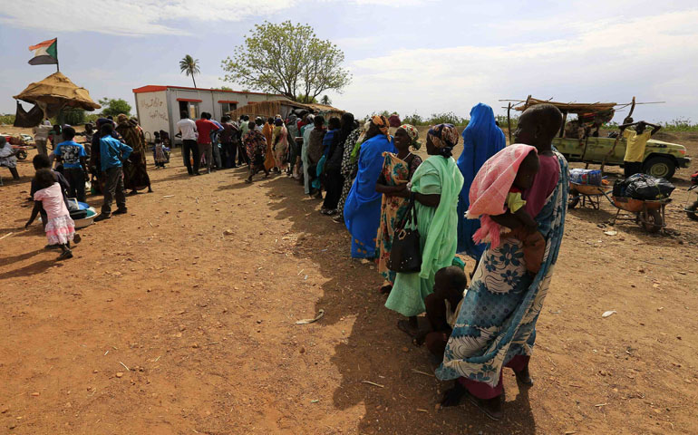 South Sudanese fleeing an attack wait to register April 19 after arriving at a border gate in Joda, along the Sudanese border. (CNS/Reuters/Mohamed Nureldin Abdallah)