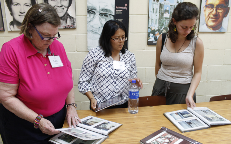 Members of a U.S. delegation interested in learning about the Salvadoran martyrs look at pictures in the Archbishop Romero Center on July 24 at Central American University in San Salvador. (CNS/Edgardo Ayala)
