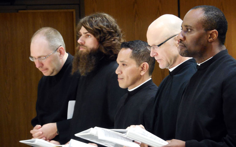 From left, Fr. Reed Mungovan, novice director, celebrates with Michael Johnson, Octavio Trejo-Flores, Patric Nikolas and Marcel Emeh during their first profession ceremony Aug. 10 at St. Anne's Salvatorian Campus Chapel in Milwaukee. (Courtesy of Society of the Divine Savior)