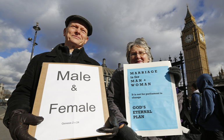 Christian activists Jonathan Longstaff and Jenny Rose, both from London, protest outside Parliament before a vote on same-sex marriage Tuesday in London. (CNS/Reuters/Chris Helgren)