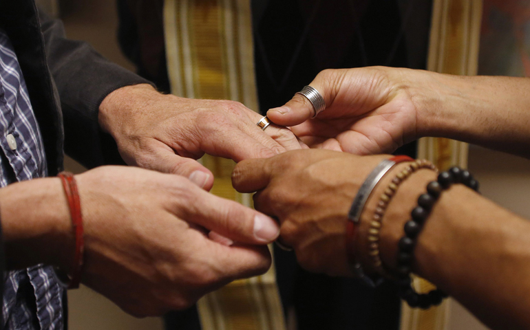 Jim Derrick and Alfie Travassos exchange rings as they get married Oct. 6 at the Salt Lake County Government Complex in Salt Lake City. (CNS/Reuters/Jim Urquhar)